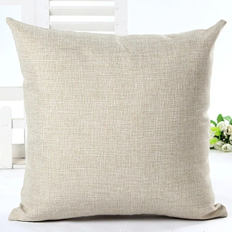 Beige pillow on a white surface with a blurred background