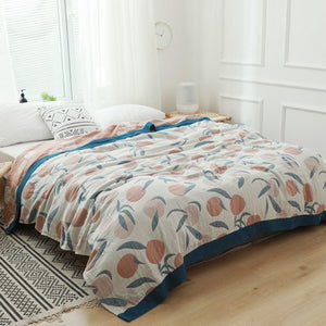 white cotton bedspread with orange and pink fruits
