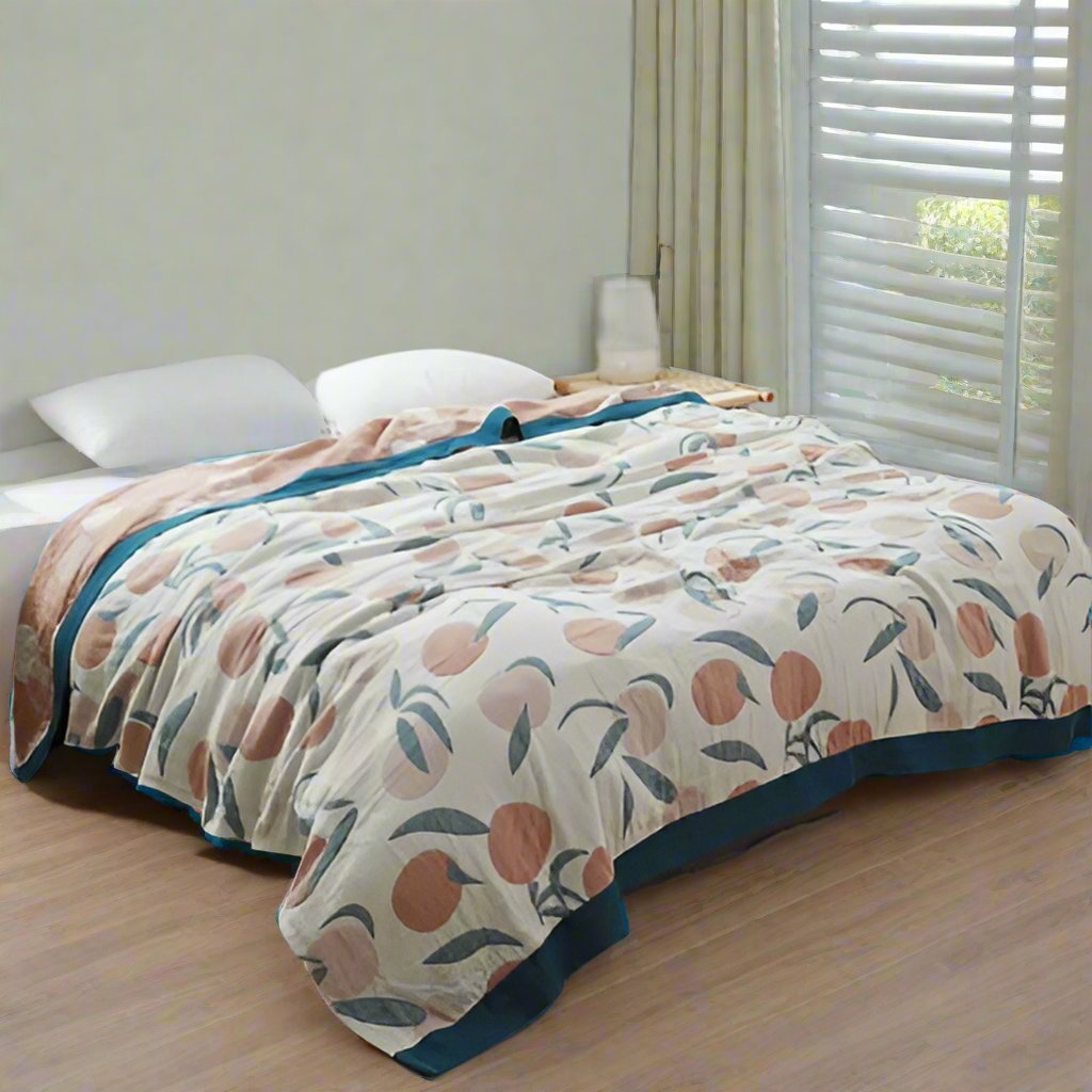 white cotton bedspread with orange and pink fruits